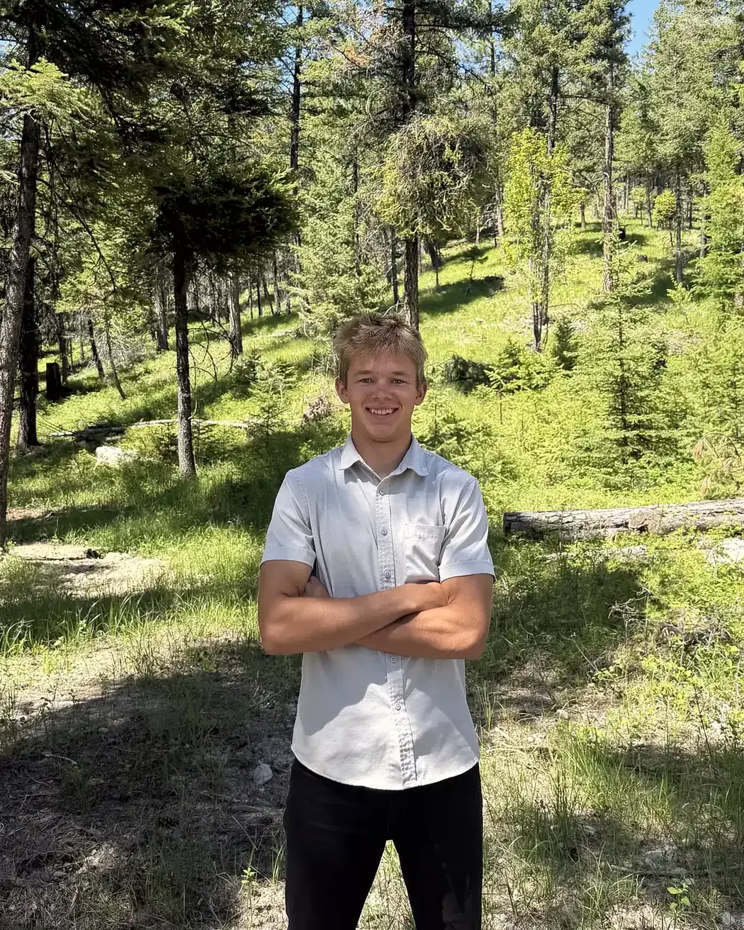 Sawyer, owner of Iron Peak Landscaping, in a pine forest near Kalispell