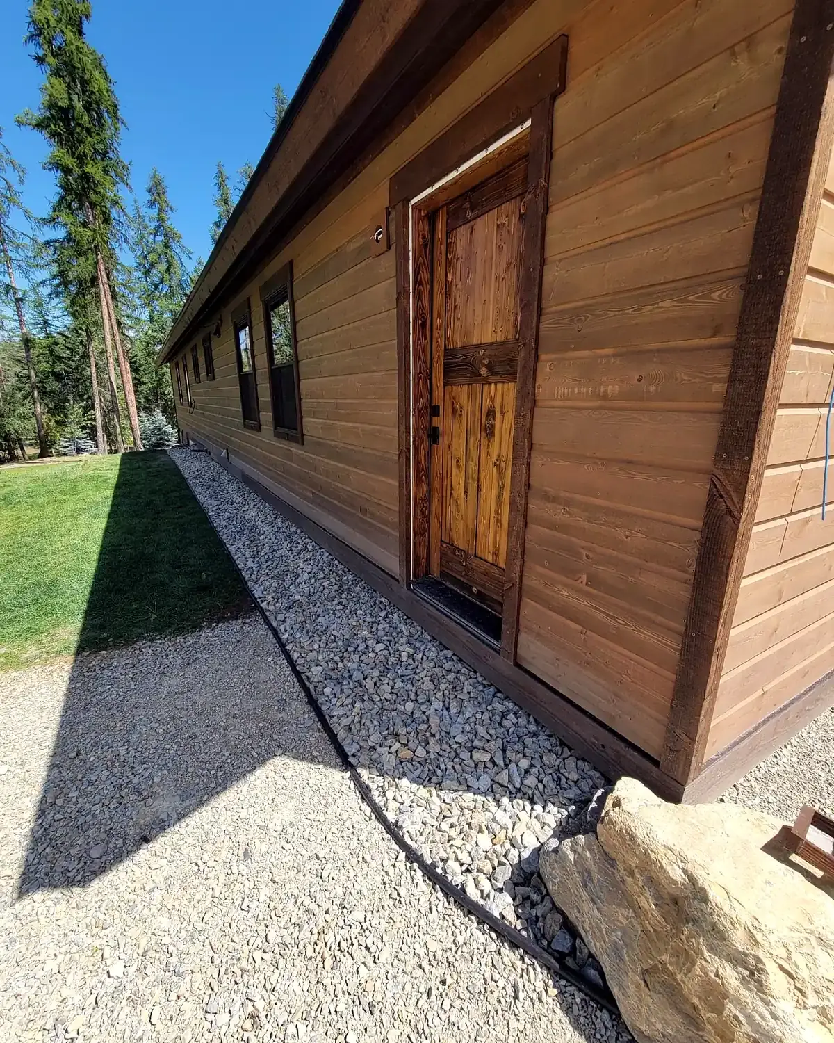 Rock and mulch bed installation along a property edge